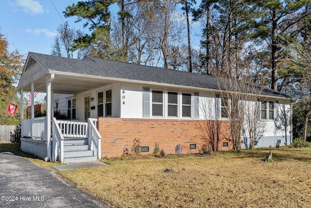 view of front of home with a porch and a front yard