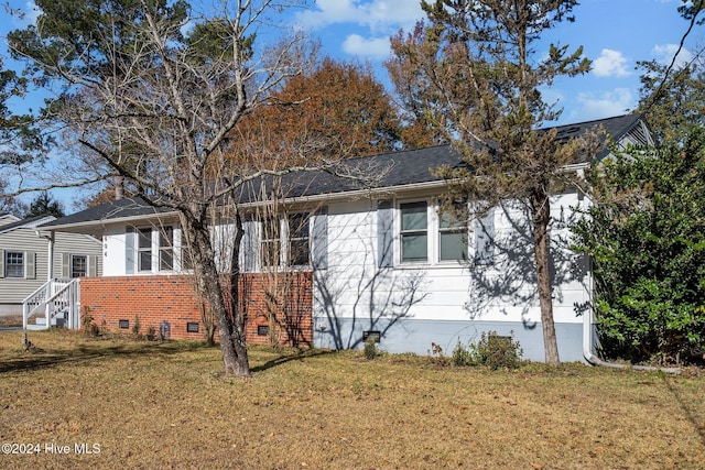 view of property exterior featuring a lawn