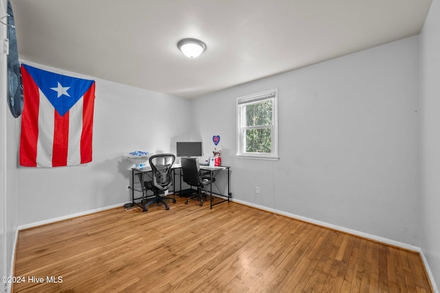 home office with wood-type flooring