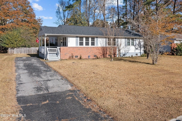 ranch-style home with a porch and a front yard