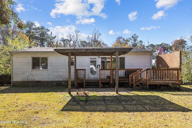 rear view of house featuring a yard and a wooden deck