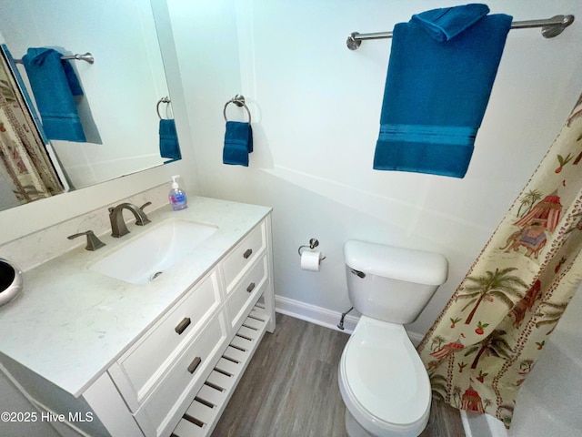 bathroom with vanity, hardwood / wood-style floors, and toilet