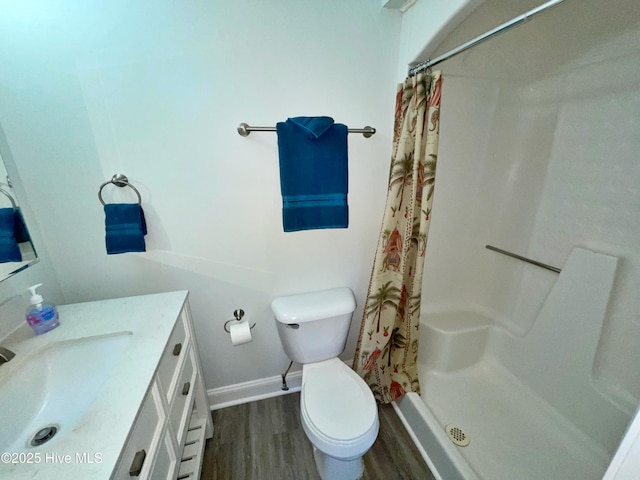 bathroom featuring wood-type flooring, toilet, curtained shower, and vanity