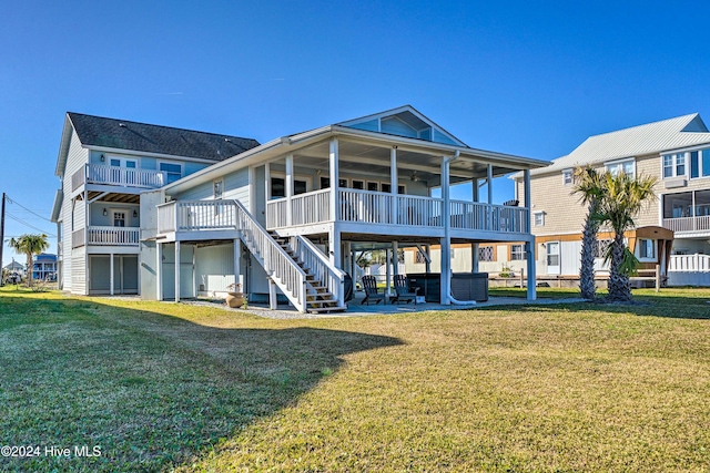 back of property with a lawn and a patio