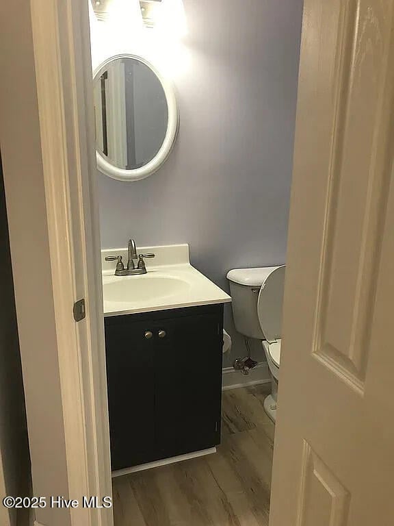 bathroom featuring hardwood / wood-style flooring, vanity, and toilet