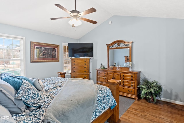 bedroom with hardwood / wood-style floors, ceiling fan, and vaulted ceiling