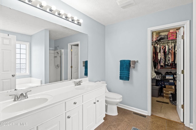 full bathroom featuring tile patterned floors, vanity, independent shower and bath, and a textured ceiling