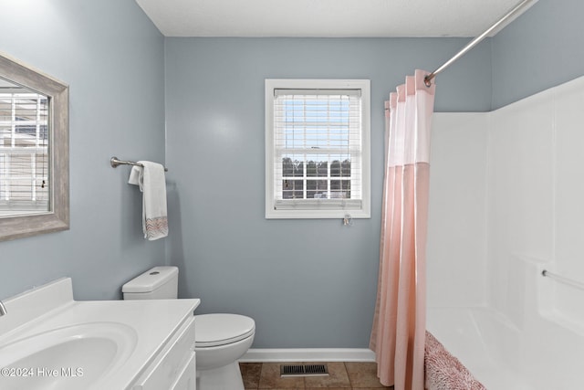 full bathroom featuring tile patterned floors, vanity, toilet, and shower / bath combo with shower curtain