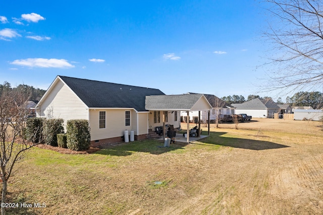 back of property featuring a yard and a patio