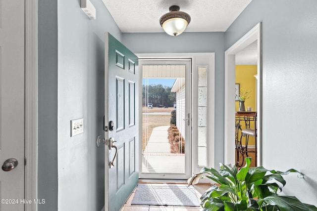 entryway with a textured ceiling