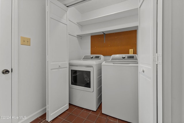 washroom featuring dark tile patterned flooring and separate washer and dryer