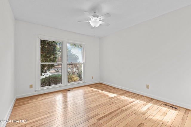 unfurnished room featuring ceiling fan and light wood-type flooring