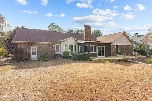 back of house featuring a sunroom and a patio