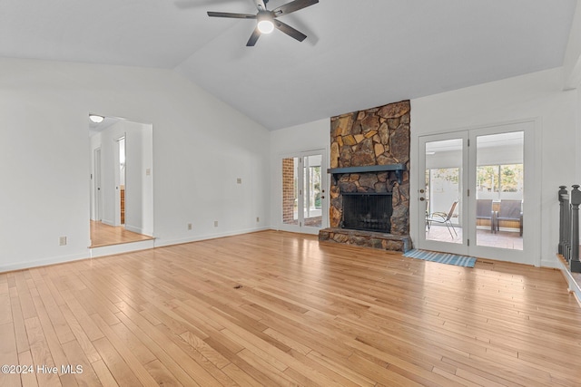 unfurnished living room with ceiling fan, a fireplace, and light hardwood / wood-style floors