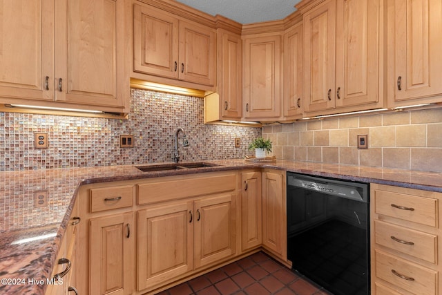 kitchen featuring sink, black dishwasher, light stone counters, backsplash, and dark tile patterned flooring