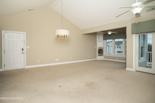 unfurnished living room with carpet flooring and high vaulted ceiling