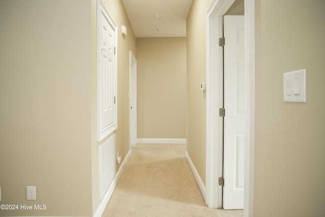 hallway with light colored carpet