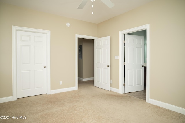 unfurnished bedroom with ceiling fan and light colored carpet