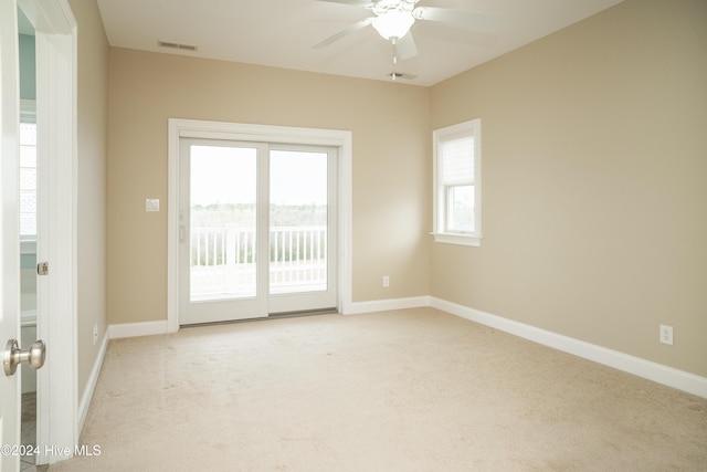 unfurnished room featuring ceiling fan and light colored carpet