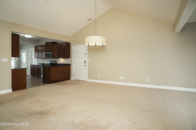 kitchen with pendant lighting, dark carpet, high vaulted ceiling, appliances with stainless steel finishes, and dark brown cabinetry