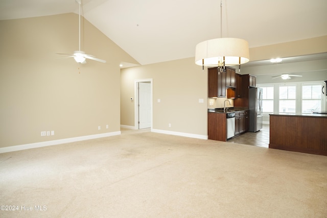 unfurnished living room featuring carpet floors, high vaulted ceiling, ceiling fan, and sink