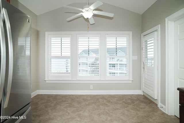 empty room featuring ceiling fan and vaulted ceiling