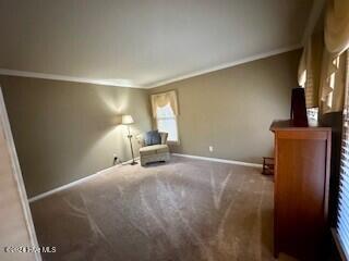 unfurnished room featuring baseboards, carpet flooring, and ornamental molding