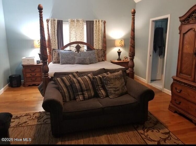 bedroom featuring baseboards and wood finished floors