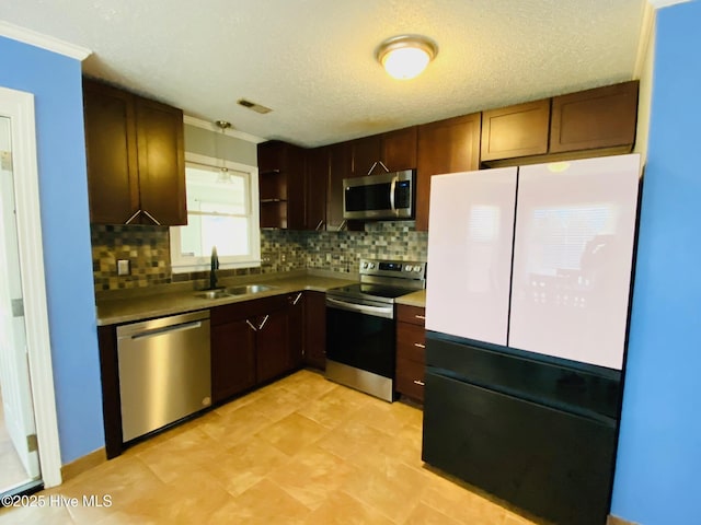 kitchen with stainless steel appliances, backsplash, decorative light fixtures, a textured ceiling, and sink