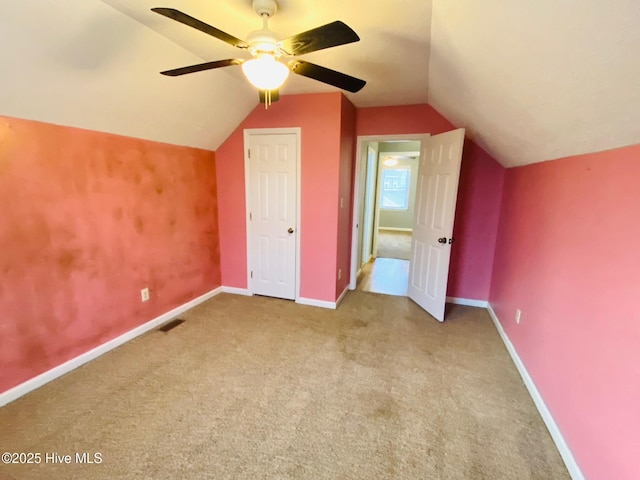 bonus room with ceiling fan, light colored carpet, and vaulted ceiling