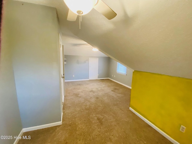 additional living space featuring vaulted ceiling, ceiling fan, and carpet