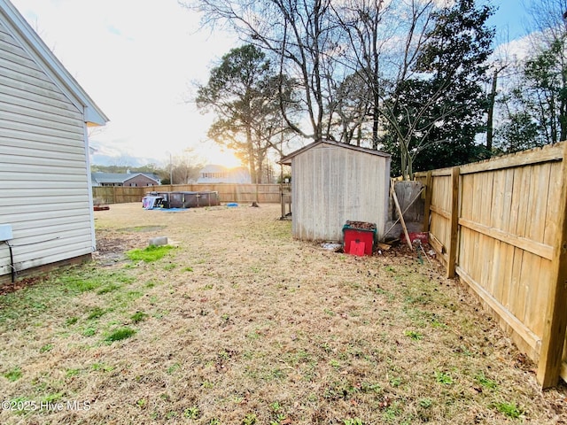 view of yard featuring a pool and a storage unit