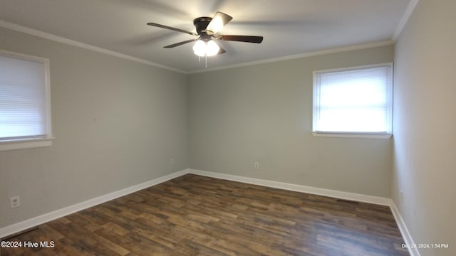 spare room with dark hardwood / wood-style floors, ceiling fan, and ornamental molding