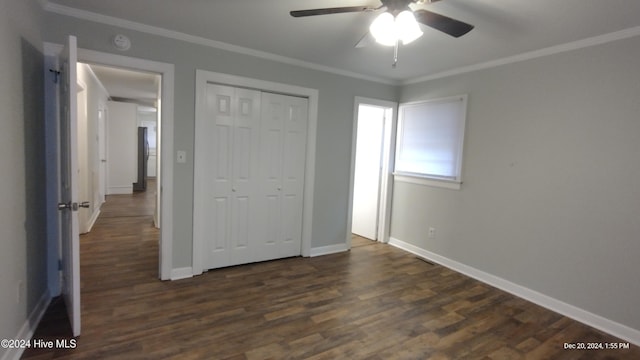 unfurnished bedroom with a closet, ceiling fan, crown molding, and dark wood-type flooring