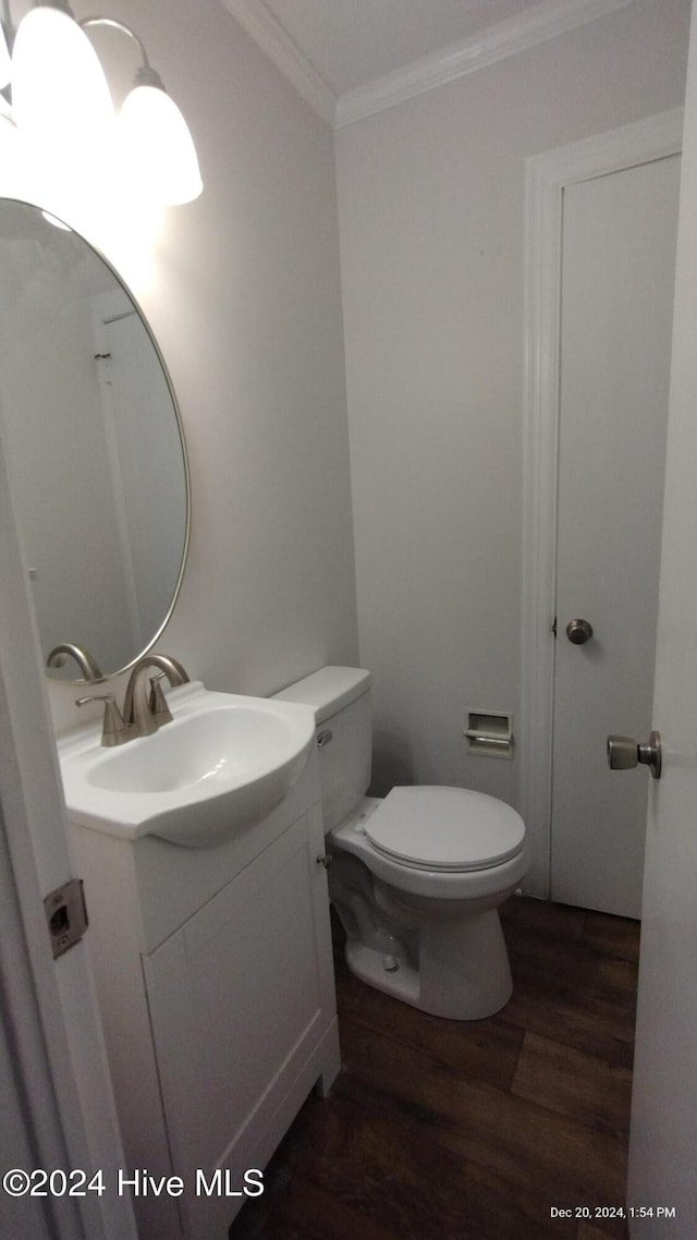 bathroom featuring crown molding, hardwood / wood-style floors, vanity, and toilet