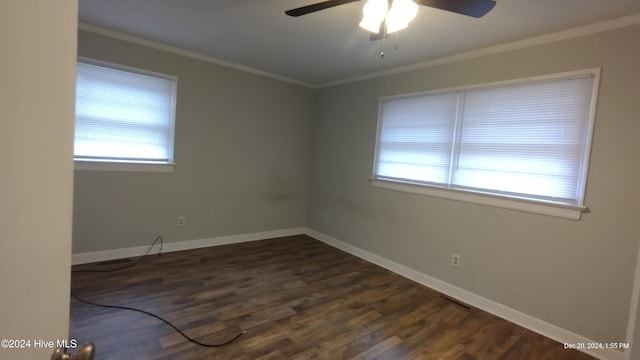 empty room featuring ceiling fan, dark hardwood / wood-style flooring, and ornamental molding