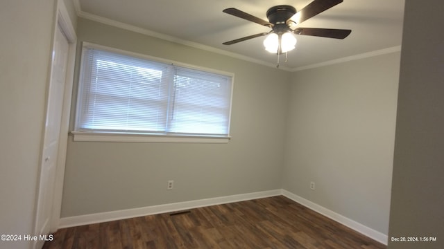 unfurnished room featuring ceiling fan, dark hardwood / wood-style floors, and ornamental molding