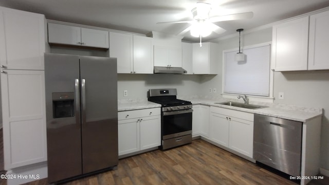 kitchen with stainless steel appliances, dark wood-type flooring, sink, white cabinetry, and hanging light fixtures