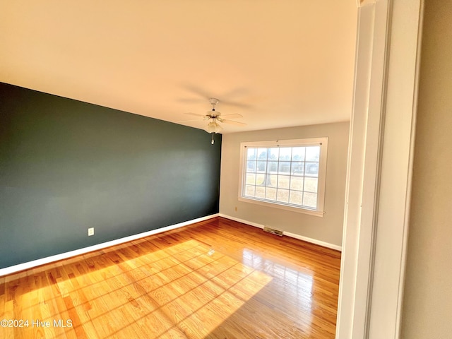 unfurnished room with ceiling fan and light hardwood / wood-style flooring