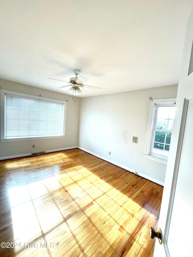 unfurnished room with light hardwood / wood-style floors and ceiling fan