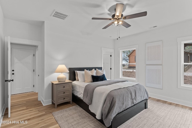 bedroom with ceiling fan and light hardwood / wood-style floors