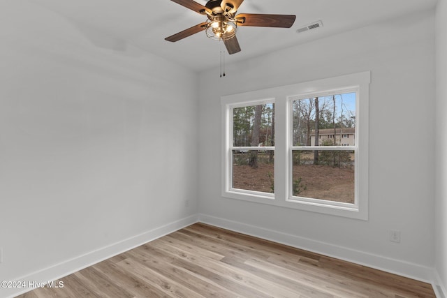 empty room with light hardwood / wood-style flooring and ceiling fan