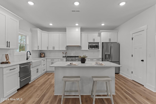 kitchen with white cabinetry and light hardwood / wood-style flooring