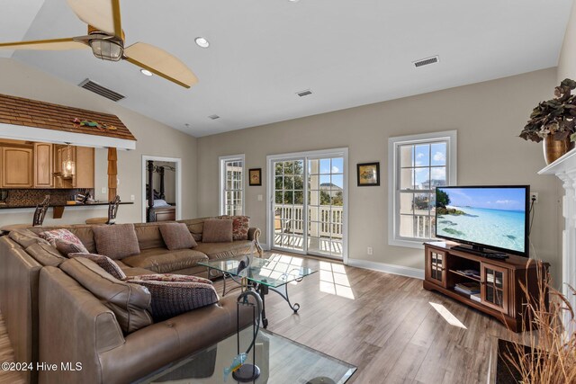 living room with light hardwood / wood-style floors and ornamental molding