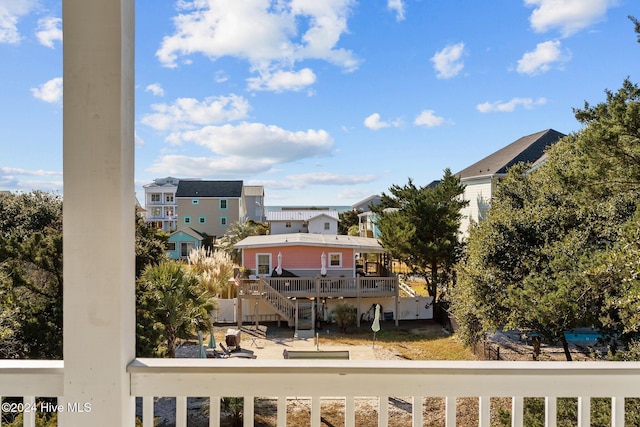 view of wooden balcony with a deck and a residential view