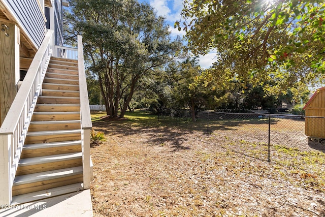 view of yard with stairway and fence