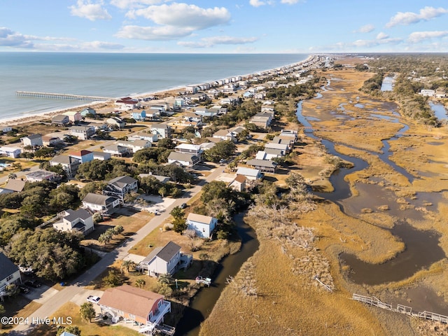 bird's eye view featuring a water view and a beach view