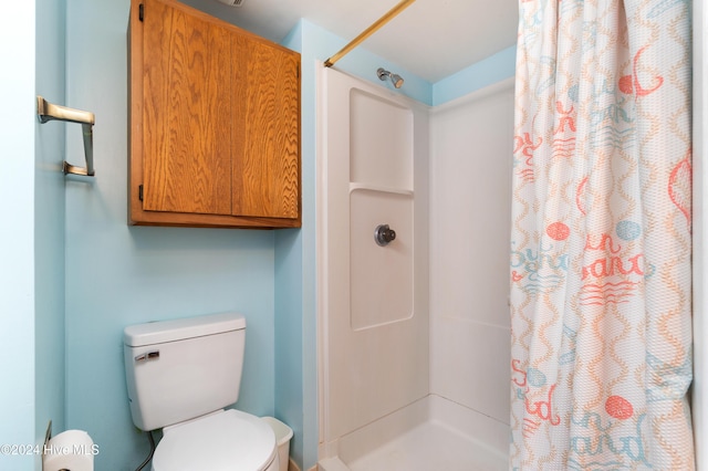 bathroom with toilet and walk in shower