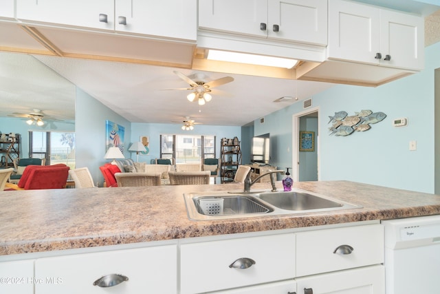 kitchen featuring white cabinetry, dishwasher, sink, and plenty of natural light