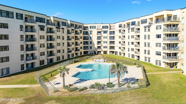 view of pool featuring a yard and a patio area